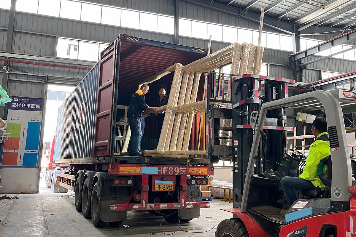 bulk aluminium window delivery arriving at a residential construction site with units secured on protective a frame stillages