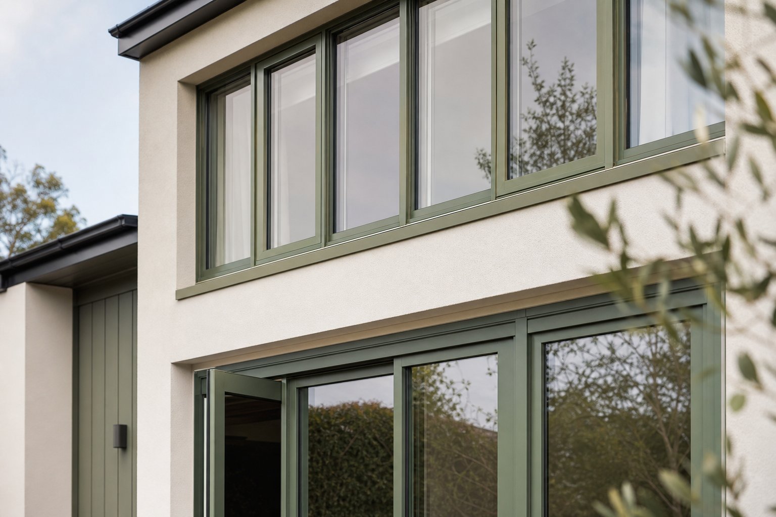 green aluminium window frames in different ral shades showing colour variation in natural daylight