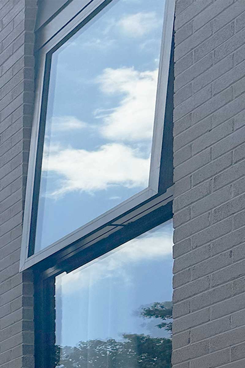 double hung aluminium window sash tilted inward for easy interior cleaning and maintenance access